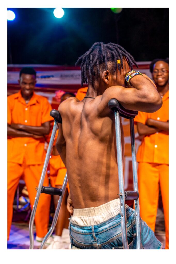 A dancer moves fluidly to the rhythm of the crowd’s applause, his muscular body moving seamlessly with his crutches. Around him, the audience cheers, swept up in the energy of the moment.This photograph celebrates the right of everyone, regardless of ability, to experience and express joy. It challenges the exclusion of disabled bodies from entertainment spaces, showcasing how music and movement can unite people across differences. The dancer’s passion reclaims space for disability within the arts, affirming that joy, creativity, and expression know no boundaries.Here, disability is not an obstacle but a force of vitality and connection. The image stands as a call for greater inclusion in the arts, reminding us that everyone deserves to dance, to be seen, and to be celebrated.