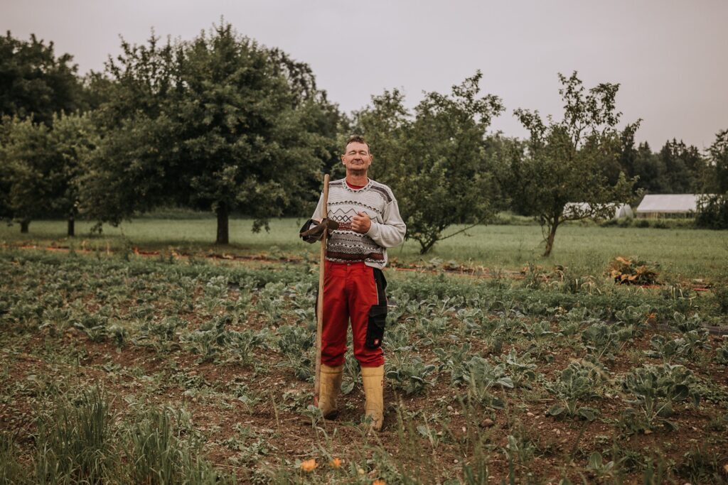 Wolfgang stands tall in the garden, hoe in hand, his yellow wellington boots bright against the soil. His gaze is steady, proud, a quiet assertion of dignity and purpose. For over two decades, he has worked at an integration gardening company where people with and without disabilities cultivate the land side by side. This photograph is part of a long-term project built on trust and shared experience. By blurring the lines between who is labelled “disabled” and who is not, the work refuses the hierarchies so often embedded in narratives of labour and care. It captures not only Wolfgang’s strength but also the radical potential of inclusive workplaces: environments rooted in respect, reciprocity, and mutual growth.