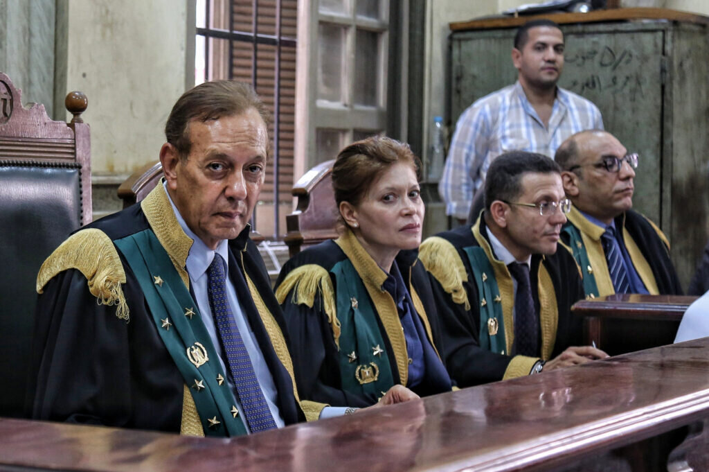 Counselor Fatima Qandil stares directly into the lens, seated among her male colleagues on the bench of Egypt’s Criminal Court. Her expression is steady, composed, unflinching.
